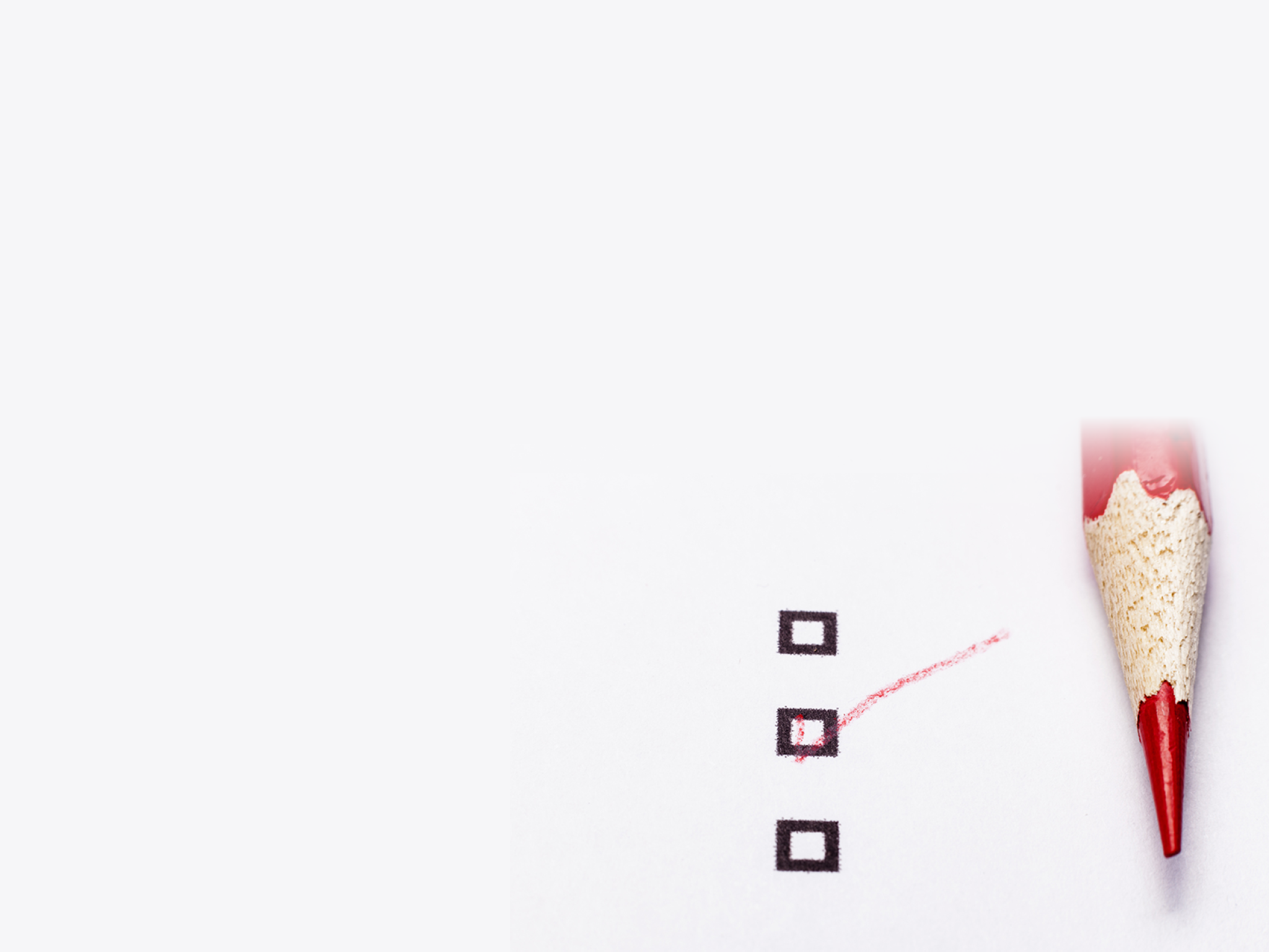 Red pencil on white paper with checkbox