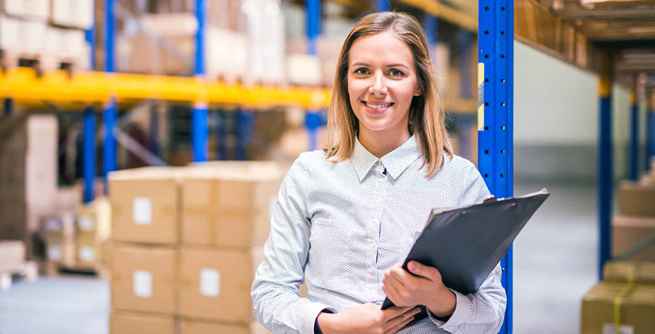 Portrait of a young woman warehouse worker or supervisor with clipboard 