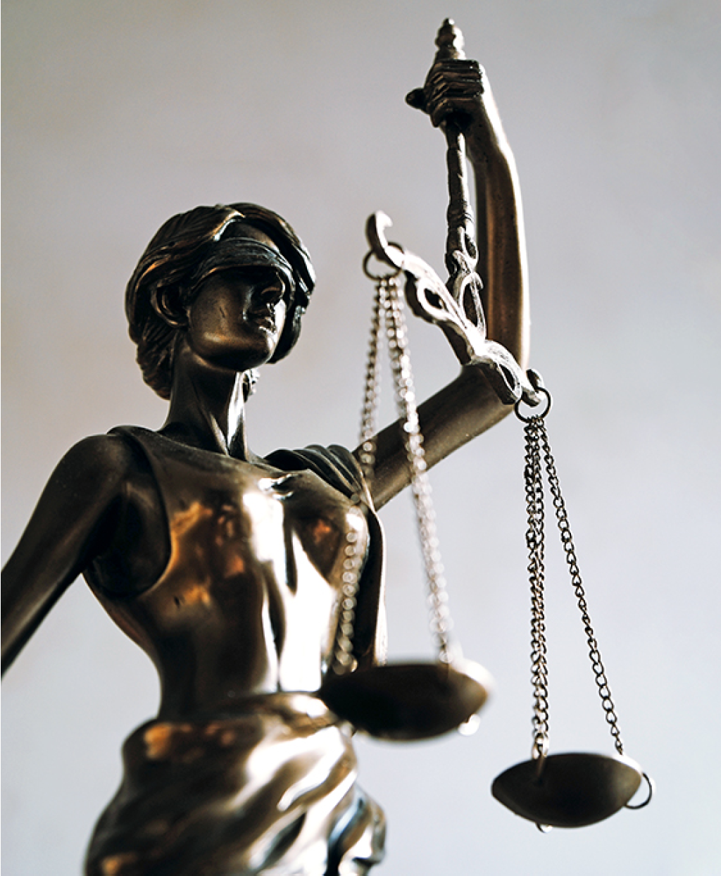 lady justice or justitia - blindfolded figurine holding balance scales - law jurisprudence and impartiality symbol - background with copy space
