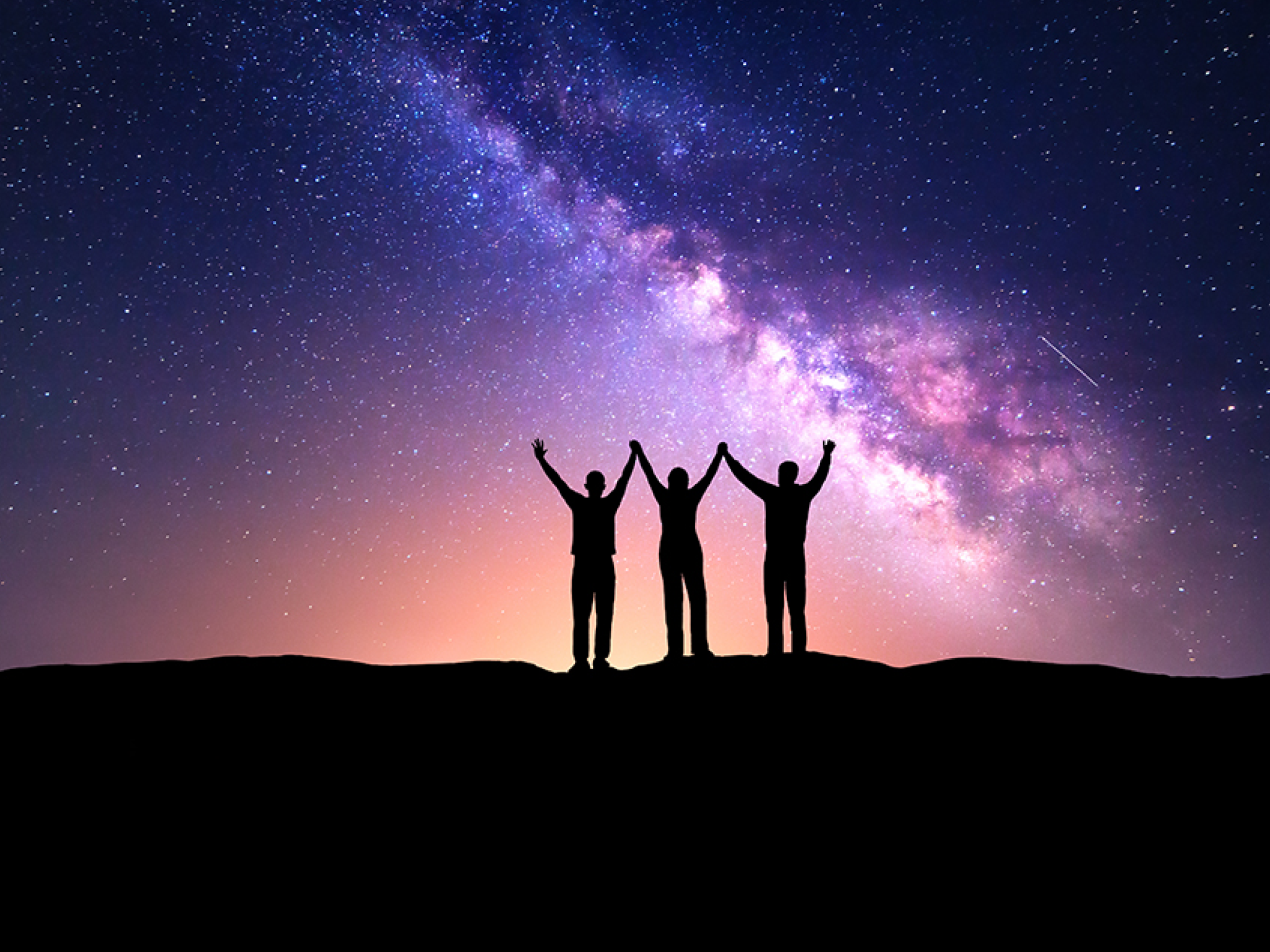 Night landscape with Milky Way and silhouette of people  Night starry sky with silhouette of happy friends with raised-up arms on the hill  Beautiful Universe  Astrophotography