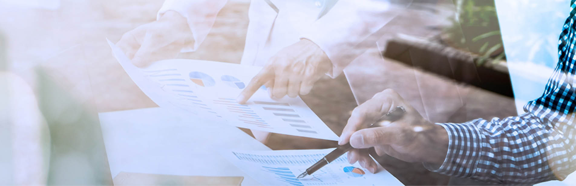 Business colleagues working together with data analysis documents behind the glass wall