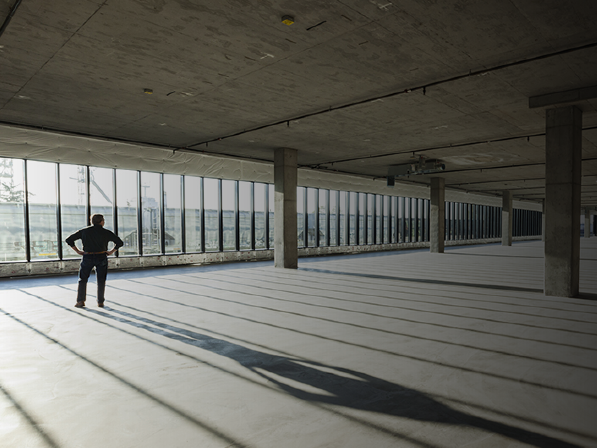 Single businessman in new empty raw business space for a new office