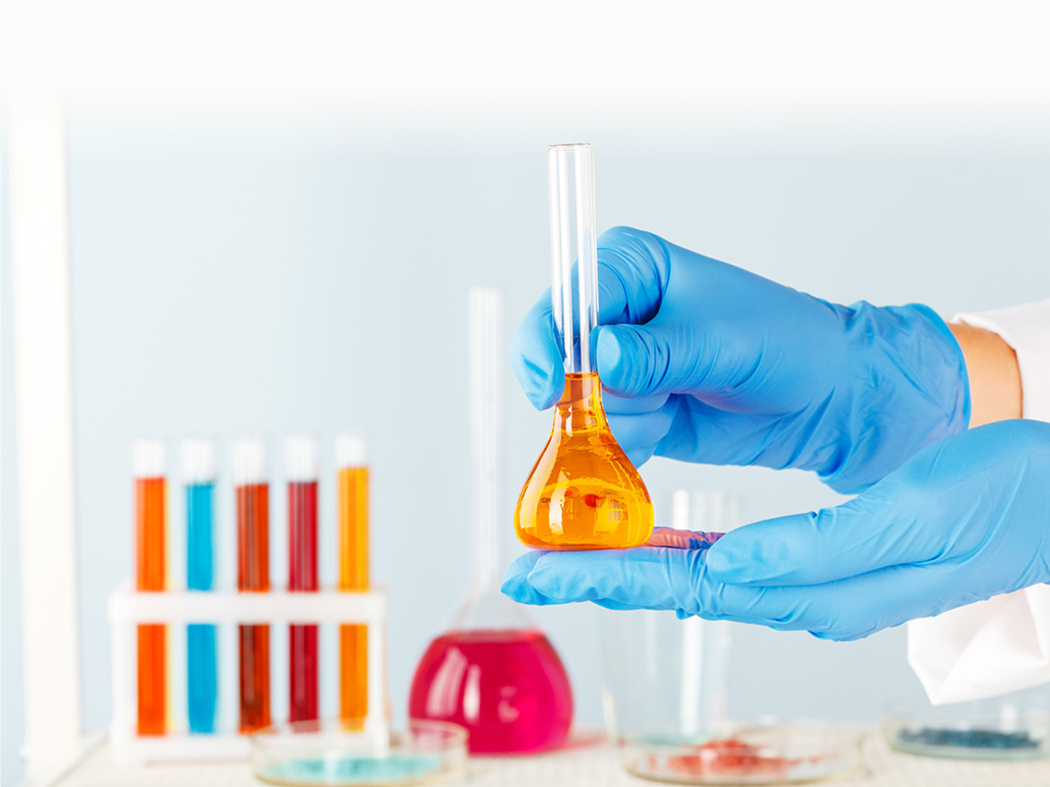 Manipulations with laboratory glass chemical containers on table