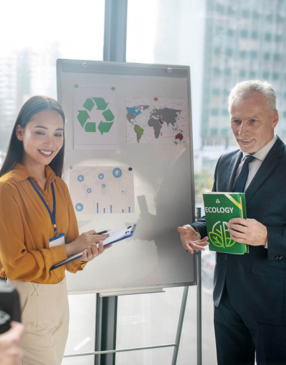 New book. Grey-haired man with a book in his hand looking excited while presenting a new book